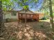Exterior of home, showing deck and tree-filled backyard and blue recycling bins at 7716 Bluff Top Court Ct, Raleigh, NC 27615