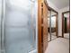 Shower room with frosted glass doors and access to a second bathroom and storage at 7716 Bluff Top Court Ct, Raleigh, NC 27615
