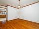 Dining room with wood floors, trim, a hanging light fixture, and an open doorway to the kitchen at 7716 Bluff Top Court Ct, Raleigh, NC 27615