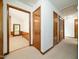 Hallway with doors, storage, and access to a living space with a fireplace at 7716 Bluff Top Court Ct, Raleigh, NC 27615