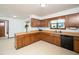 Functional kitchen featuring wooden cabinets, a peninsula, and ample counter space at 7716 Bluff Top Court Ct, Raleigh, NC 27615