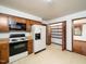 Kitchen with wood cabinets, modern appliances, and a walk-in pantry nearby at 7716 Bluff Top Court Ct, Raleigh, NC 27615