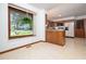 Bright kitchen with wood cabinets, a breakfast bar, and a large window with a view at 7716 Bluff Top Court Ct, Raleigh, NC 27615