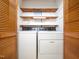 Laundry room with a washer, dryer, wood doors, and shelving at 7716 Bluff Top Court Ct, Raleigh, NC 27615