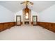 Large living room with a brick fireplace, high ceiling, wood trim and neutral carpet at 7716 Bluff Top Court Ct, Raleigh, NC 27615