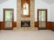 Cozy living room with a brick fireplace, complemented by glass doors and wood paneling at 7716 Bluff Top Court Ct, Raleigh, NC 27615