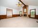 Spacious living room featuring a brick fireplace, beamed ceiling, and wood-paneled accent wall at 7716 Bluff Top Court Ct, Raleigh, NC 27615