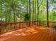 Spacious wood deck with painted wood railings and wooded backyard at 7716 Bluff Top Court Ct, Raleigh, NC 27615