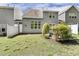 Manicured backyard with lush lawn, attractive landscaping and shrubbery, privacy fence, and patio for entertaining and relaxation at 7728 Cape Charles Dr, Raleigh, NC 27617
