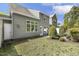 Charming backyard featuring a lush lawn, a small water feature, a patio, and mature landscaping for outdoor enjoyment at 7728 Cape Charles Dr, Raleigh, NC 27617