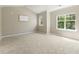 Neutral bedroom with carpet, natural light, and en suite bathroom at 7728 Cape Charles Dr, Raleigh, NC 27617