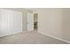 Bright bedroom featuring neutral carpet, baseboards, and an open doorway at 7728 Cape Charles Dr, Raleigh, NC 27617