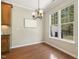 Hardwood dining area with overhead chandelier and natural light at 7728 Cape Charles Dr, Raleigh, NC 27617