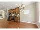 Dining area with hardwood floors, a view of the backyard, and a charming light fixture at 7728 Cape Charles Dr, Raleigh, NC 27617