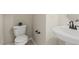 Clean half bathroom featuring a toilet and pedestal sink at 7728 Cape Charles Dr, Raleigh, NC 27617