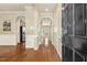 Elegant hallway with hardwood floors, arched doorways, and white wainscoting at 7728 Cape Charles Dr, Raleigh, NC 27617