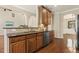 Open kitchen with granite countertops, stainless steel dishwasher, and hardwood cabinets at 7728 Cape Charles Dr, Raleigh, NC 27617