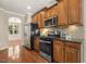 Kitchen features stainless steel appliances, hardwood cabinets, and granite countertops at 7728 Cape Charles Dr, Raleigh, NC 27617