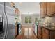 Spacious kitchen with stainless steel appliances, hardwood floors, and a view to the backyard at 7728 Cape Charles Dr, Raleigh, NC 27617