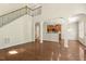 Spacious living room featuring hardwood floors, archways, and views into the kitchen at 7728 Cape Charles Dr, Raleigh, NC 27617
