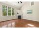 Bright living room featuring hardwood floors, fireplace, and large windows offering natural light and views at 7728 Cape Charles Dr, Raleigh, NC 27617