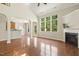 Bright and open living room with hardwood floors, fireplace, and large windows overlooking the backyard at 7728 Cape Charles Dr, Raleigh, NC 27617