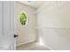 Walk-in closet with oval window and white wire shelving at 7728 Cape Charles Dr, Raleigh, NC 27617