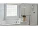 Bathroom featuring a soaking tub and glass enclosed shower at 792 Eldridge Loop, Cary, NC 27519