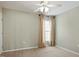 Well-lit bedroom features carpet, a ceiling fan, and natural light from the window with curtains at 792 Eldridge Loop, Cary, NC 27519