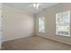 Well-lit bedroom features carpet, a ceiling fan, and natural light from the two windows at 792 Eldridge Loop, Cary, NC 27519