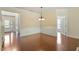 Bright dining room featuring wainscoting, wood floors and a stylish light fixture at 792 Eldridge Loop, Cary, NC 27519