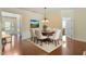 Inviting dining area with hardwood floors, elegant chandelier and access to the living spaces at 792 Eldridge Loop, Cary, NC 27519