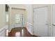 Bright foyer with hardwood floors, wainscoting, and a glass-paneled door at 792 Eldridge Loop, Cary, NC 27519