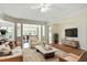 Spacious living room with hardwood floors, a ceiling fan, and an open floor plan to the dining area at 792 Eldridge Loop, Cary, NC 27519