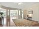 Elegant living room with a neutral rug, hardwood floors, and an open view of the adjacent living space at 792 Eldridge Loop, Cary, NC 27519