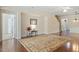 Cozy living room features wood floors, area rug and easy access to the upstairs and other living spaces at 792 Eldridge Loop, Cary, NC 27519