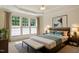Bedroom with tray ceiling, windows, and furnishings at 792 Eldridge Loop, Cary, NC 27519