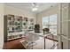 Bright office space featuring hardwood floors, built-in bookshelves, and a sleek white desk at 792 Eldridge Loop, Cary, NC 27519
