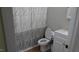 Well-lit bathroom featuring a modern toilet, vanity, and a patterned shower curtain at 82 Whisper Ln, Pittsboro, NC 27312