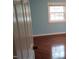 Light-filled bedroom with wood floors, a blue accent wall, and a window with a white frame at 82 Whisper Ln, Pittsboro, NC 27312
