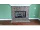 Close-up of a tiled fireplace with a decorative mantle in a room with hardwood floors at 82 Whisper Ln, Pittsboro, NC 27312