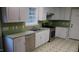 Well-lit kitchen showcasing stainless steel appliances, green counters, and ample cabinet space at 82 Whisper Ln, Pittsboro, NC 27312