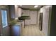 Bright kitchen with white cabinets, stainless steel appliances, and a green and white geometric floor at 82 Whisper Ln, Pittsboro, NC 27312