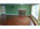 Spacious living room with hardwood floors, a cozy fireplace, and natural light from large windows at 82 Whisper Ln, Pittsboro, NC 27312