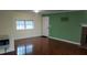 Open living area with hardwood floors, natural light, and a view of the tiled fireplace at 82 Whisper Ln, Pittsboro, NC 27312