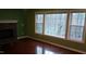 Inviting living room featuring hardwood floors, a cozy fireplace, and large windows at 82 Whisper Ln, Pittsboro, NC 27312