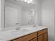 Bathroom featuring double sinks, a mirror, and wood cabinets at 90 Cordoba Dr, Franklinton, NC 27525
