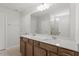 Well-lit bathroom with double vanity sinks and a large mirror highlighting the neutral walls at 90 Cordoba Dr, Franklinton, NC 27525