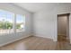 Bedroom featuring wood-look floors and two large windows at 90 Cordoba Dr, Franklinton, NC 27525