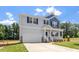 Charming two-story home with gray siding, blue accents, covered porch, and well-manicured lawn at 90 Cordoba Dr, Franklinton, NC 27525